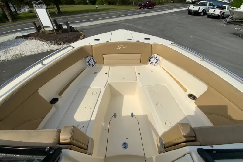 Slide: The Image of 2019 Scout 255 Dorado boat interior with tan seating and storage compartments. - 20