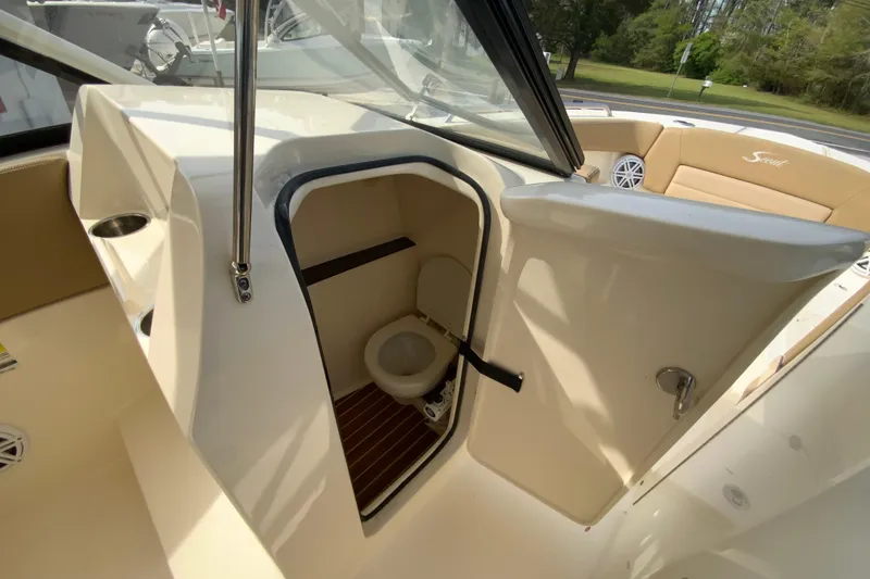 Slide: The Image of 2019 Scout 255 Dorado boat interior with open door revealing compact toilet. - 21