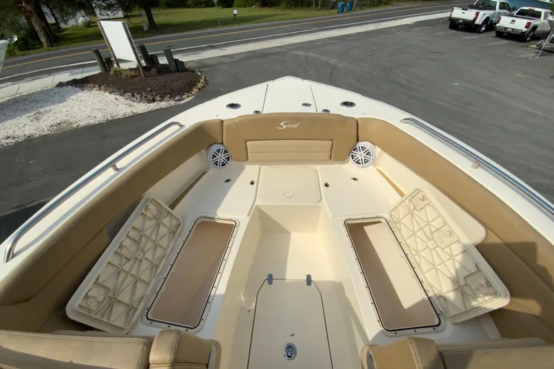 Slide: The Image of 2019 Scout 255 Dorado boat interior with beige seating and storage compartments. - 22