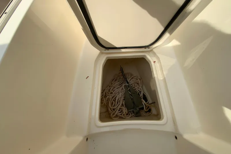 Slide: The Image of Anchor storage compartment on 2019 Scout 255 Dorado boat with rope and anchor. - 23