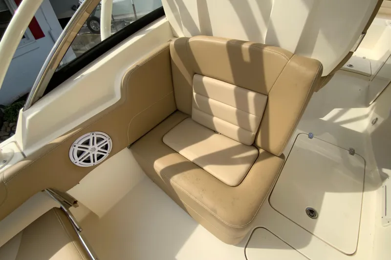 Slide: The Image of 2019 Scout 255 Dorado boat interior with tan leather seating and speaker. - 26