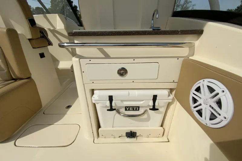 Slide: The Image of 2019 Scout 255 Dorado boat interior with Yeti cooler and speaker. - 28