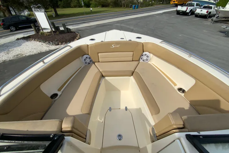 Slide: The Image of 2019 Scout 255 Dorado boat interior with tan seating and cup holders. - 29