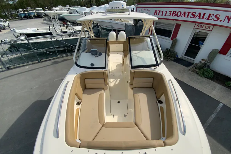Slide: The Image of 2019 Scout 255 Dorado boat with spacious seating, displayed at a boat sales lot. - 30