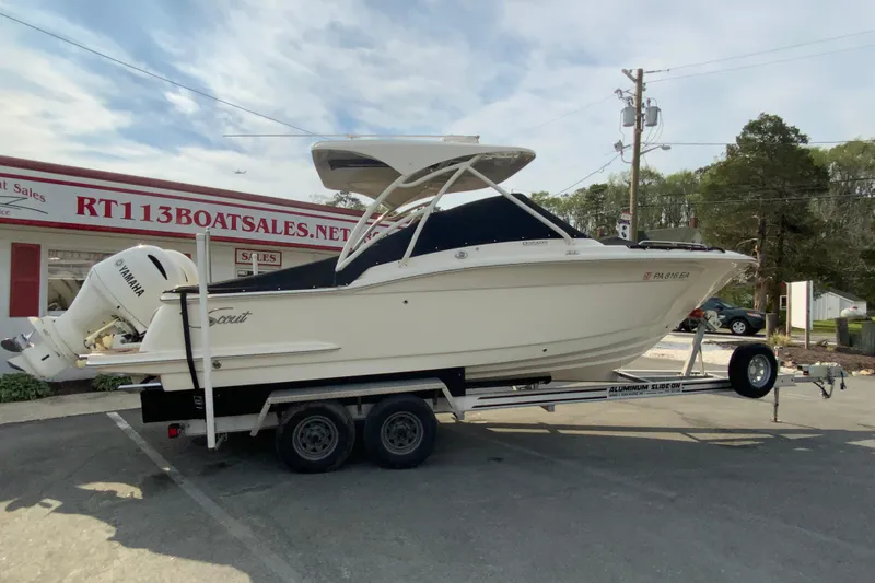 Slide: The Image of 2019 Scout 255 Dorado boat on trailer at dealership, featuring Yamaha engine. - 33