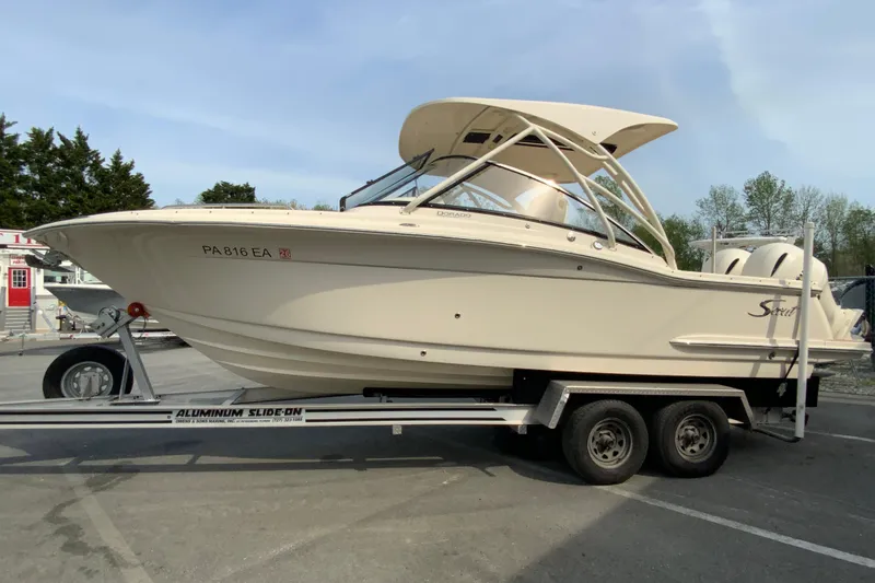 Slide: The Image of 2019 Scout 255 Dorado boat on trailer, parked outdoors. - 6