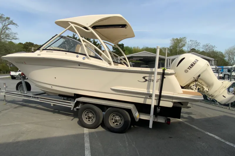 Slide: The Image of 2019 Scout 255 Dorado boat on trailer with Yamaha engine in parking lot. - 7