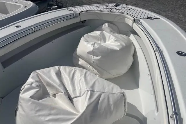 Slide: The Image of 2017 Yellowfin 26 Hybrid boat interior with white seating cushions. - 10