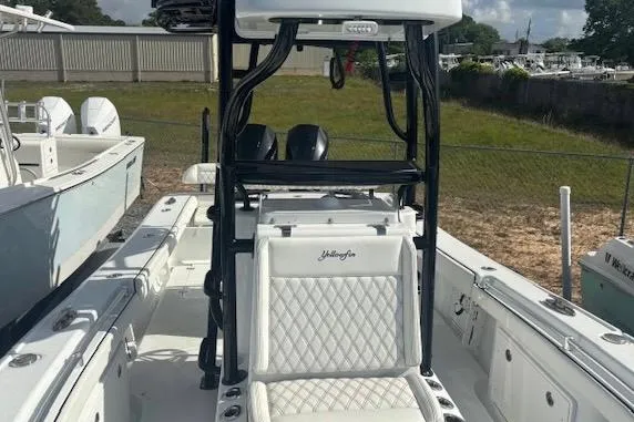 Slide: The Image of 2017 Yellowfin 26 Hybrid boat interior with white seating and black frame. - 12