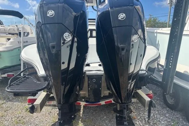 Slide: The Image of 2017 Yellowfin 26 Hybrid boat with dual Mercury outboard engines, parked on a trailer. - 4
