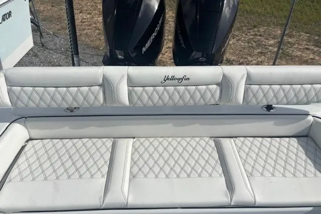 Slide: The Image of 2017 Yellowfin 26 Hybrid boat interior with diamond-stitched seating and dual Mercury engines. - 6