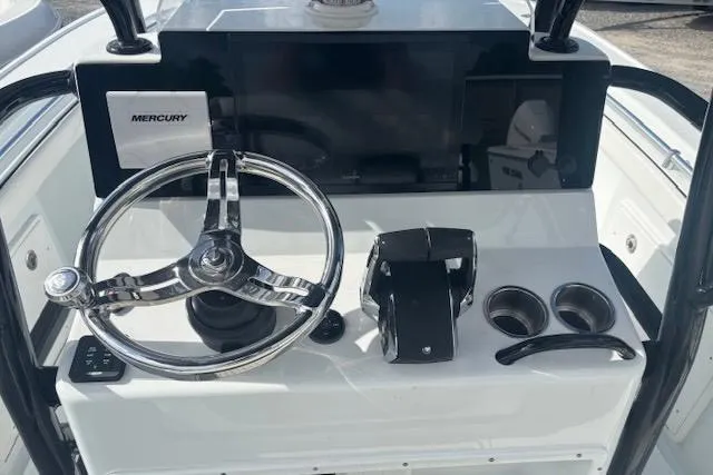 Slide: The Image of Control panel of a 2017 Yellowfin 26 Hybrid boat with Mercury steering wheel. - 7