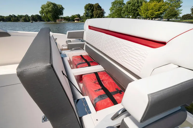 Slide: The Image of Manufacturer Provided Image: 2021 Tiara Sport 34 LS boat with under-seat storage and life jackets on a lake. - 14