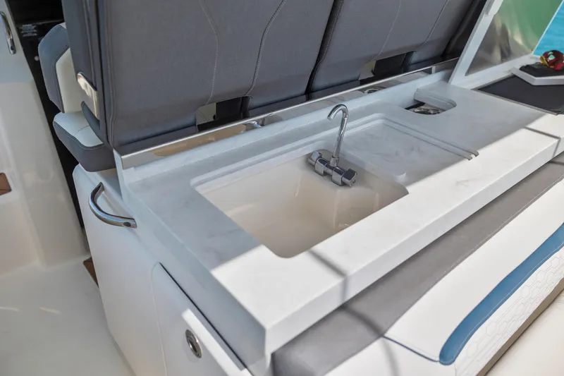 Slide: The Image of 2021 Tiara Sport 34 LS boat interior with a sleek sink and faucet setup. - 22