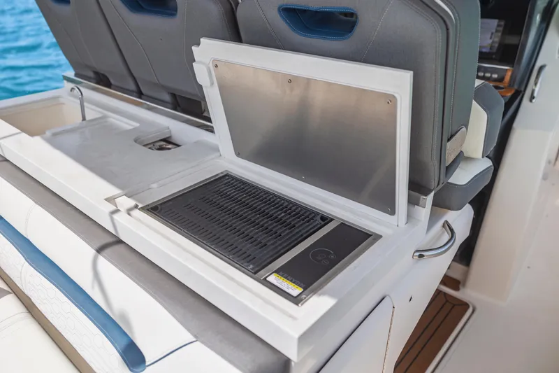 Slide: The Image of Outdoor grill and sink on 2021 Tiara Sport 34 LS boat, with seating and ocean view. - 23