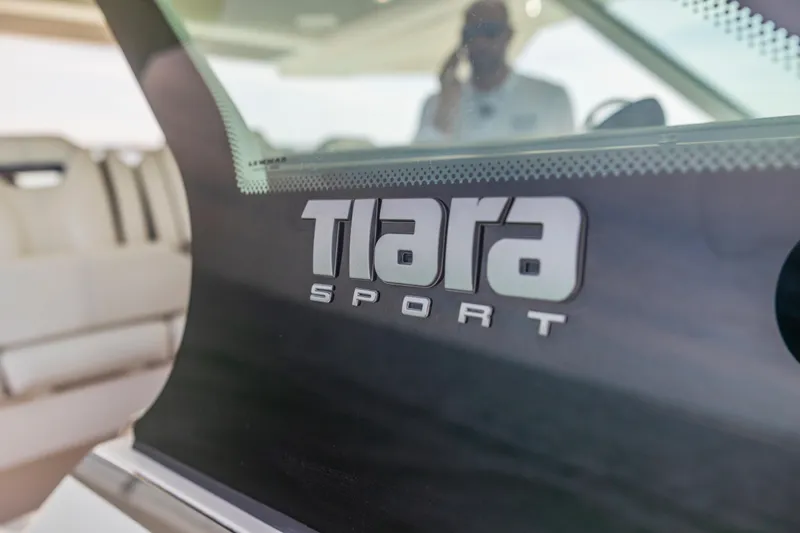 Slide: The Image of Close-up of 2021 Tiara Sport 34 LS logo on boat windshield. - 26