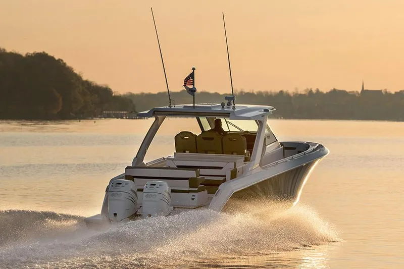 Slide: The Image of Manufacturer Provided Image: 2021 Tiara Sport 34 LS boat cruising on a calm lake at sunset. - 3