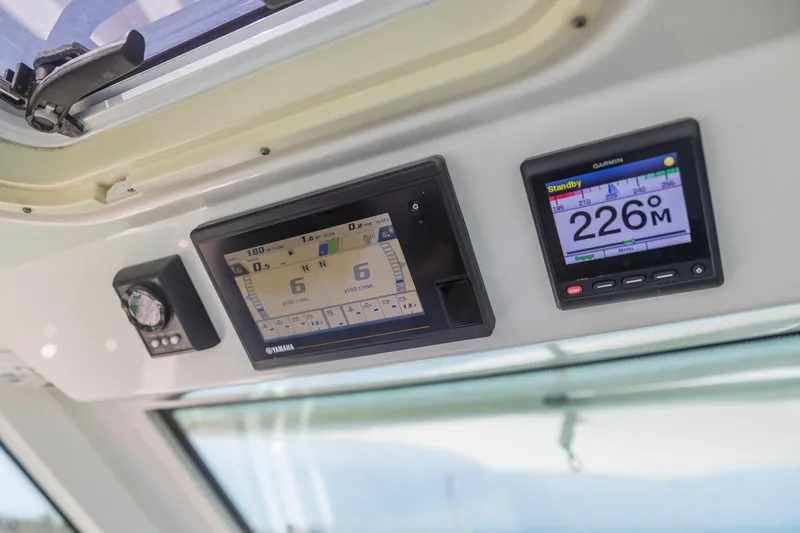 Slide: The Image of Dashboard of 2021 Tiara Sport 34 LS with Yamaha and Garmin displays. - 30
