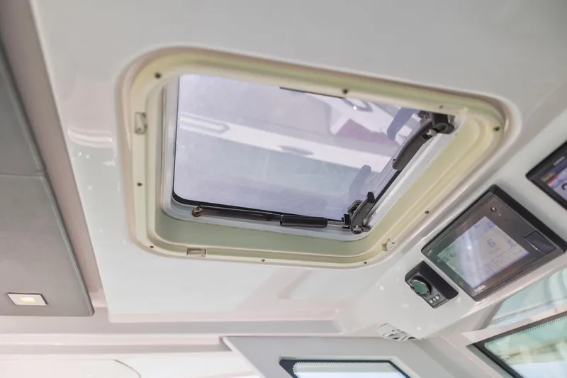 Slide: The Image of 2021 Tiara Sport 34 LS boat interior with hatch and control panel. - 34