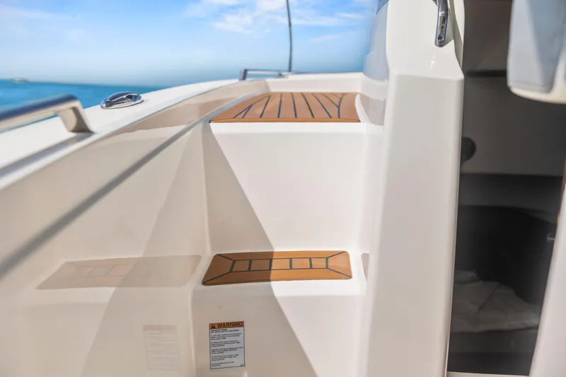 Slide: The Image of 2021 Tiara Sport 34 LS boat interior with wooden steps and ocean view. - 37