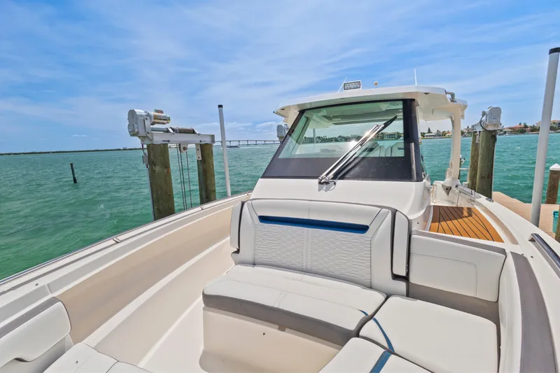 Slide: The Image of 2021 Tiara Sport 34 LS boat docked by turquoise water under clear sky. - 43
