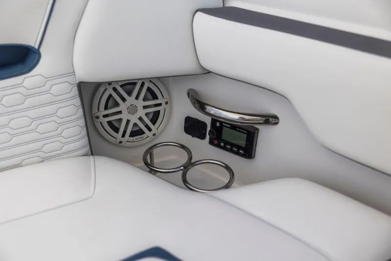 Slide: The Image of Interior of 2021 Tiara Sport 34 LS featuring speaker, control panel, and cup holders. - 46