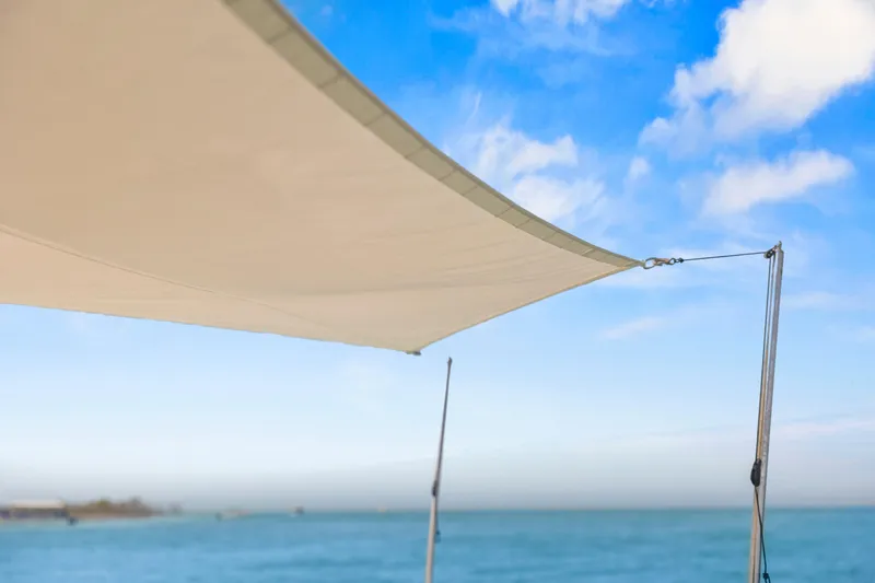 Slide: The Image of Sunshade on a 2021 Tiara Sport 34 LS boat against a clear blue sky. - 47