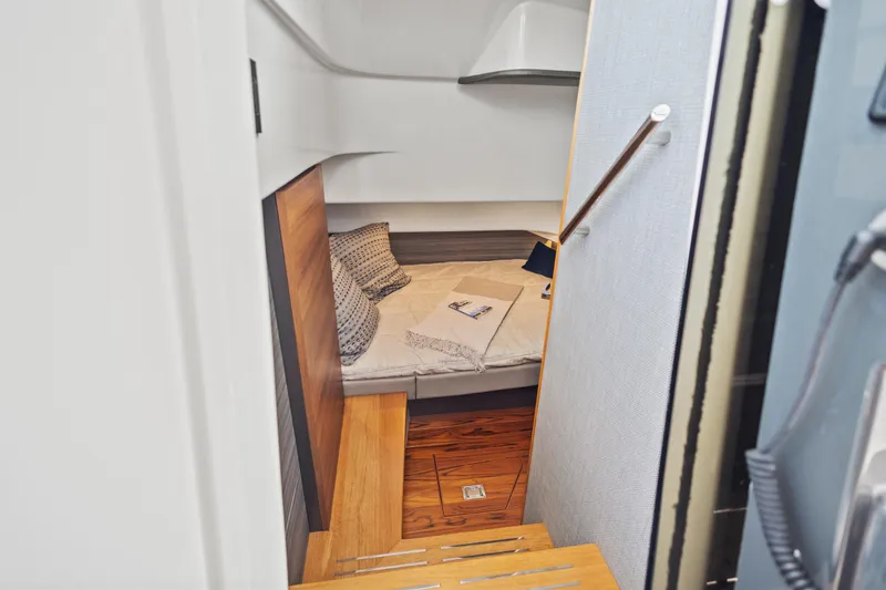 Slide: The Image of Cozy cabin interior of 2021 Tiara Sport 34 LS with wooden steps and bedding. - 49