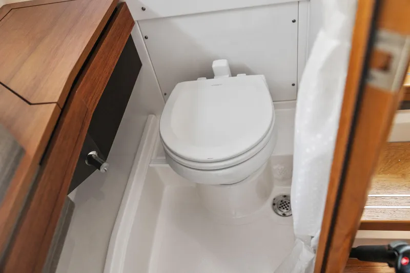 Slide: The Image of 2021 Tiara Sport 34 LS boat bathroom with modern toilet and wooden cabinetry. - 61