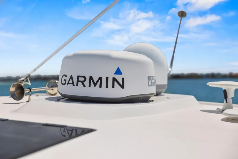 Slide: The Image of Garmin radar on 2021 Tiara Sport 34 LS boat under clear blue sky. - 65