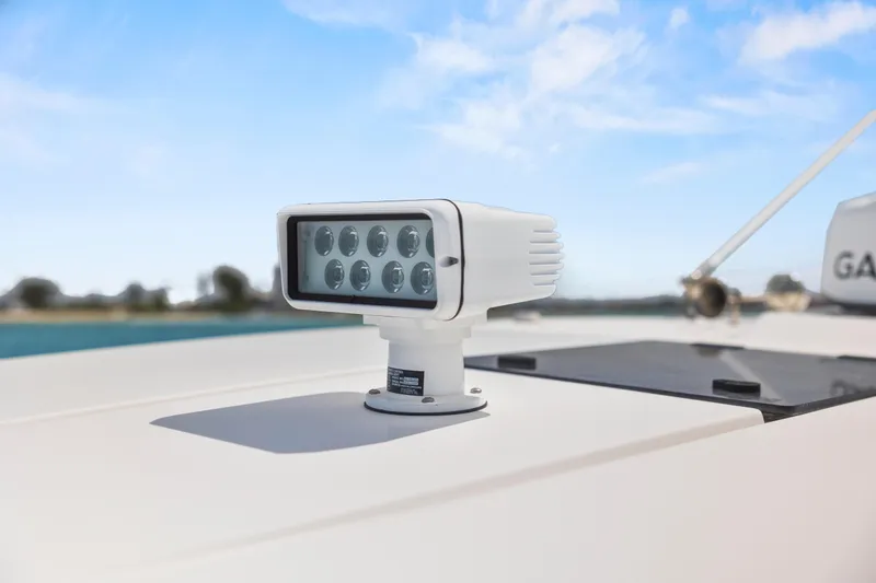 Slide: The Image of LED spotlight on 2021 Tiara Sport 34 LS boat under clear blue sky. - 66