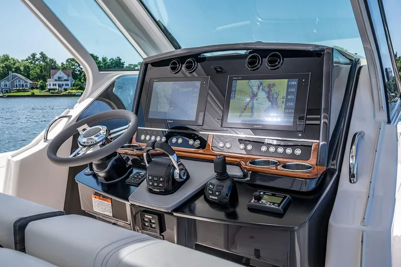 Slide: The Image of Manufacturer Provided Image: 2021 Tiara Sport 34 LS boat dashboard with dual screens and controls. - 8