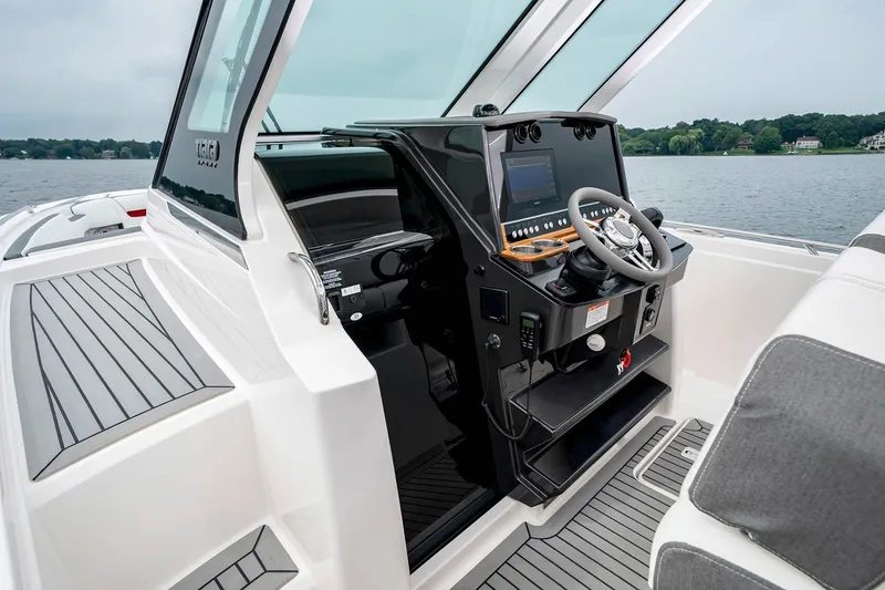 Slide: The Image of Manufacturer Provided Image: 2021 Tiara Sport 34 LS boat helm with modern controls and lake view. - 9