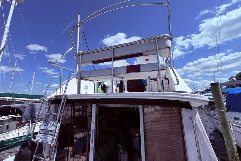 Slide: The Image of 1987 Sea Ray 340 Sedan Bridge yacht docked, featuring upper deck - 10