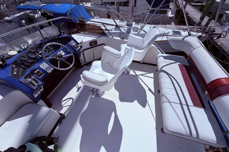 Slide: The Image of 1987 Sea Ray 340 Sedan Bridge cockpit with steering wheel, seating, and control panel. - 13
