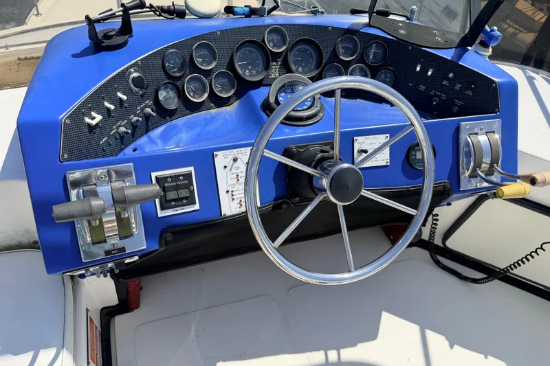 Slide: The Image of 1987 Sea Ray 340 Sedan Bridge upper helm with gauges and steering wheel. - 15