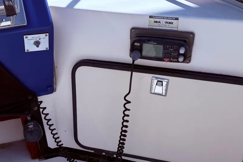 Slide: The Image of 1987 Sea Ray 340 Sedan Bridge dashboard with radio and speaker transfer switch. - 22