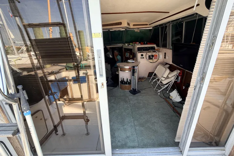 Slide: The Image of Interior view of 1987 Sea Ray 340 Sedan Bridge boat with helm and seating area. - 25
