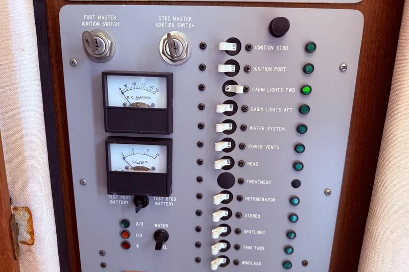 Slide: The Image of Control panel of a 1987 Sea Ray 340 Sedan Bridge with switches and gauges. - 32