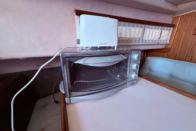 Slide: The Image of Toaster oven and toaster in 1987 Sea Ray 340 Sedan Bridge cabin kitchen. - 47