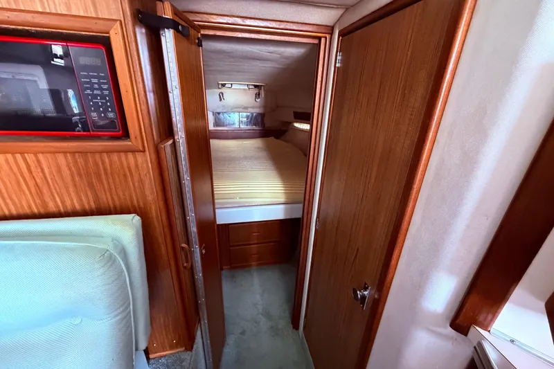 Slide: The Image of 1987 Sea Ray 340 Sedan Bridge cabin interior view from the dinette area into the v berth - 51