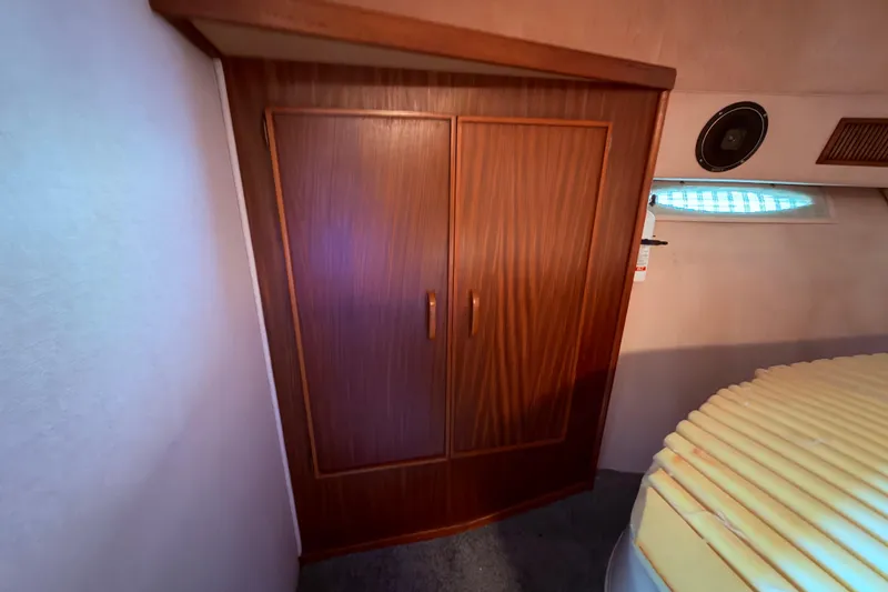 Slide: The Image of Interior of 1987 Sea Ray 340 Sedan Bridge , v berth with large storage closet - 54