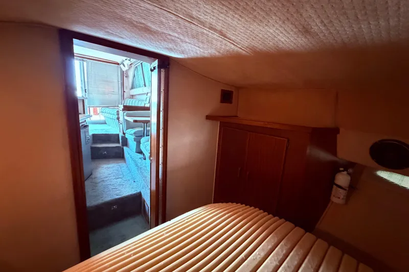 Slide: The Image of Interior view of 1987 Sea Ray 340 Sedan Bridge, featuring cozy cabin and seating area. - 56