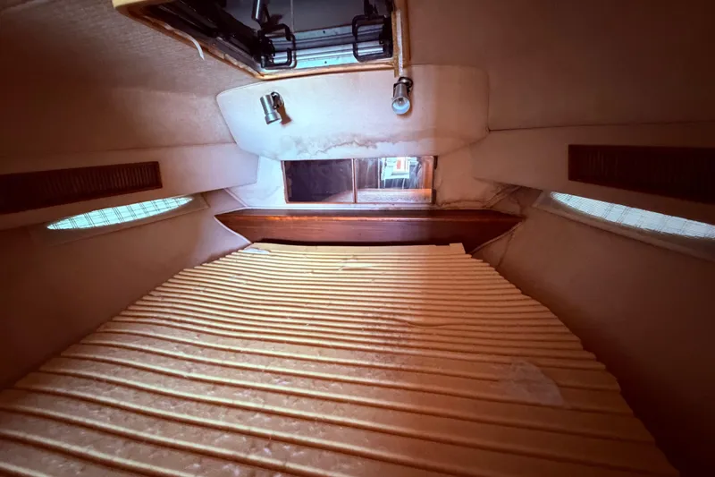 Slide: The Image of Interior cabin of 1987 Sea Ray 340 Sedan Bridge with mattress topper on the double walk around bed - 57