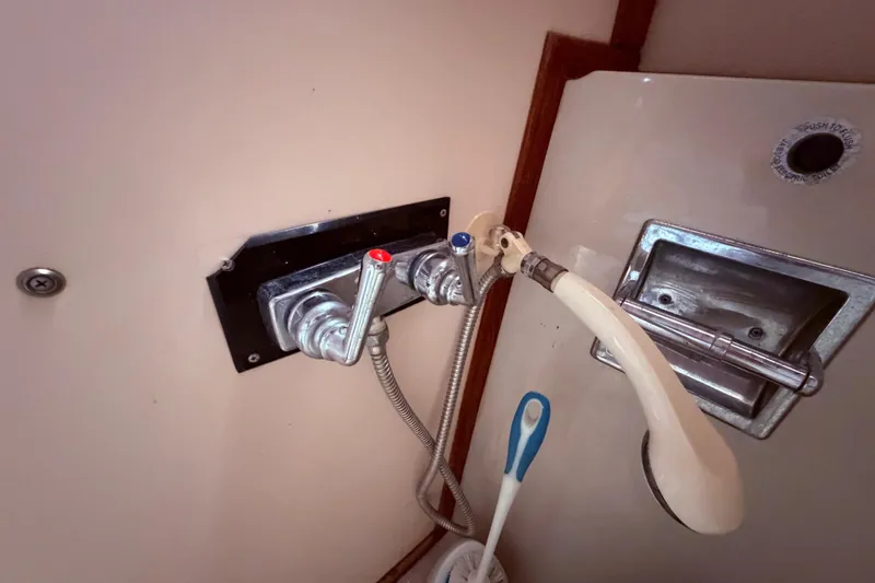 Slide: The Image of 1987 Sea Ray 340 Sedan Bridge bathroom faucet and showerhead detail. - 61
