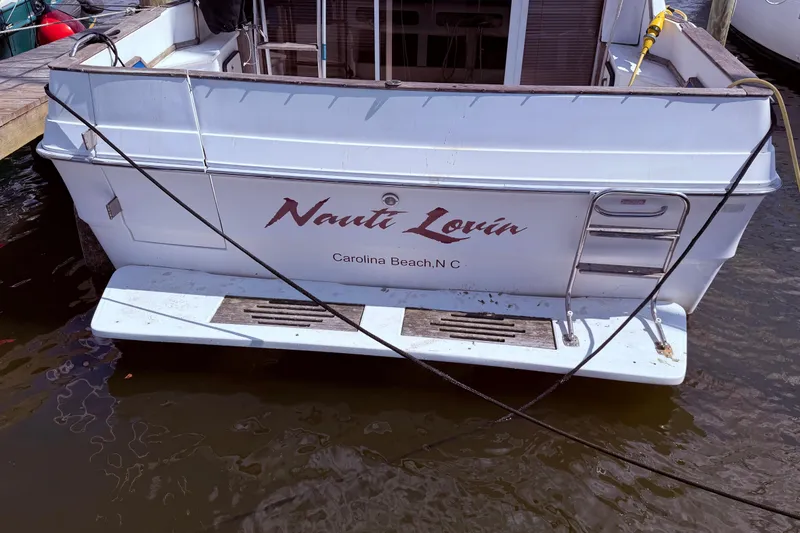 Slide: The Image of 1987 Sea Ray 340 Sedan Bridge boat docked, named "Nauti Lovin," Carolina Beach, NC. - 7