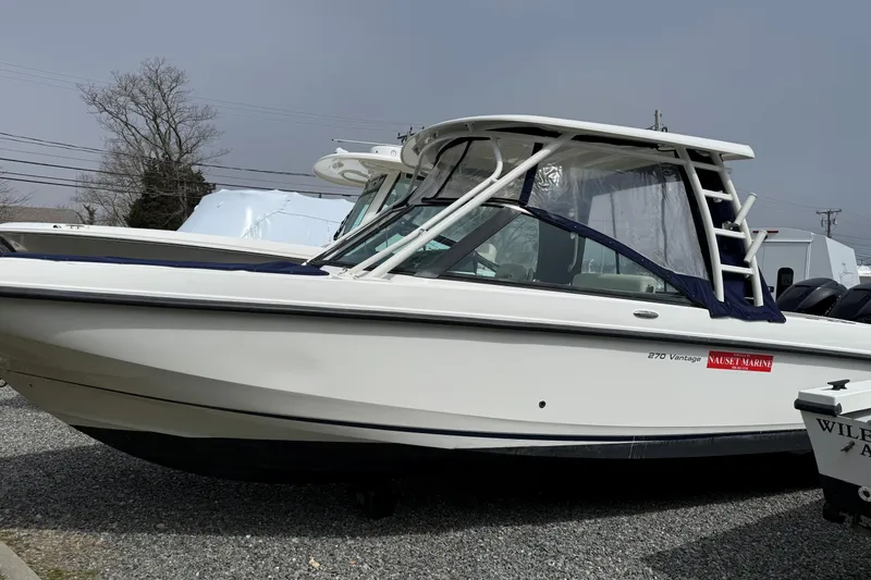 The Image of 2015 Boston Whaler 270 Vantage boat on display in a marina setting. - 0