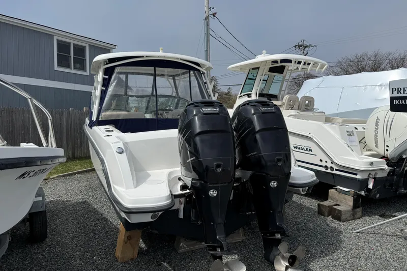Slide: The Image of 2015 Boston Whaler 270 Vantage boat with dual outboard engines on display. - 2