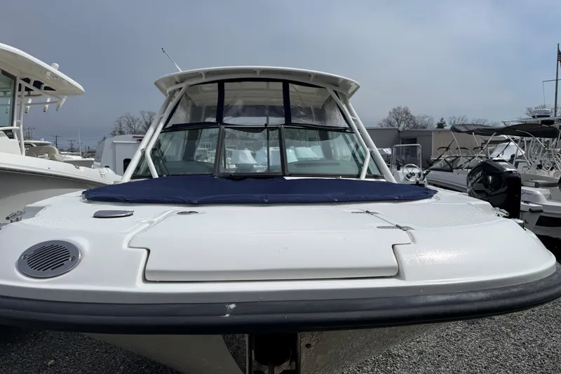 Slide: The Image of 2015 Boston Whaler 270 Vantage boat, front view, in a marina setting. - 3