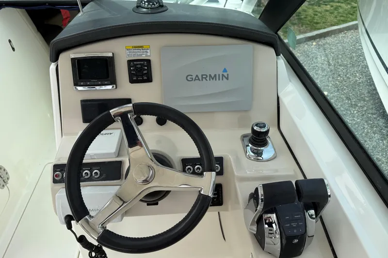 Slide: The Image of 2015 Boston Whaler 270 Vantage helm with Garmin navigation system and steering wheel. - 6